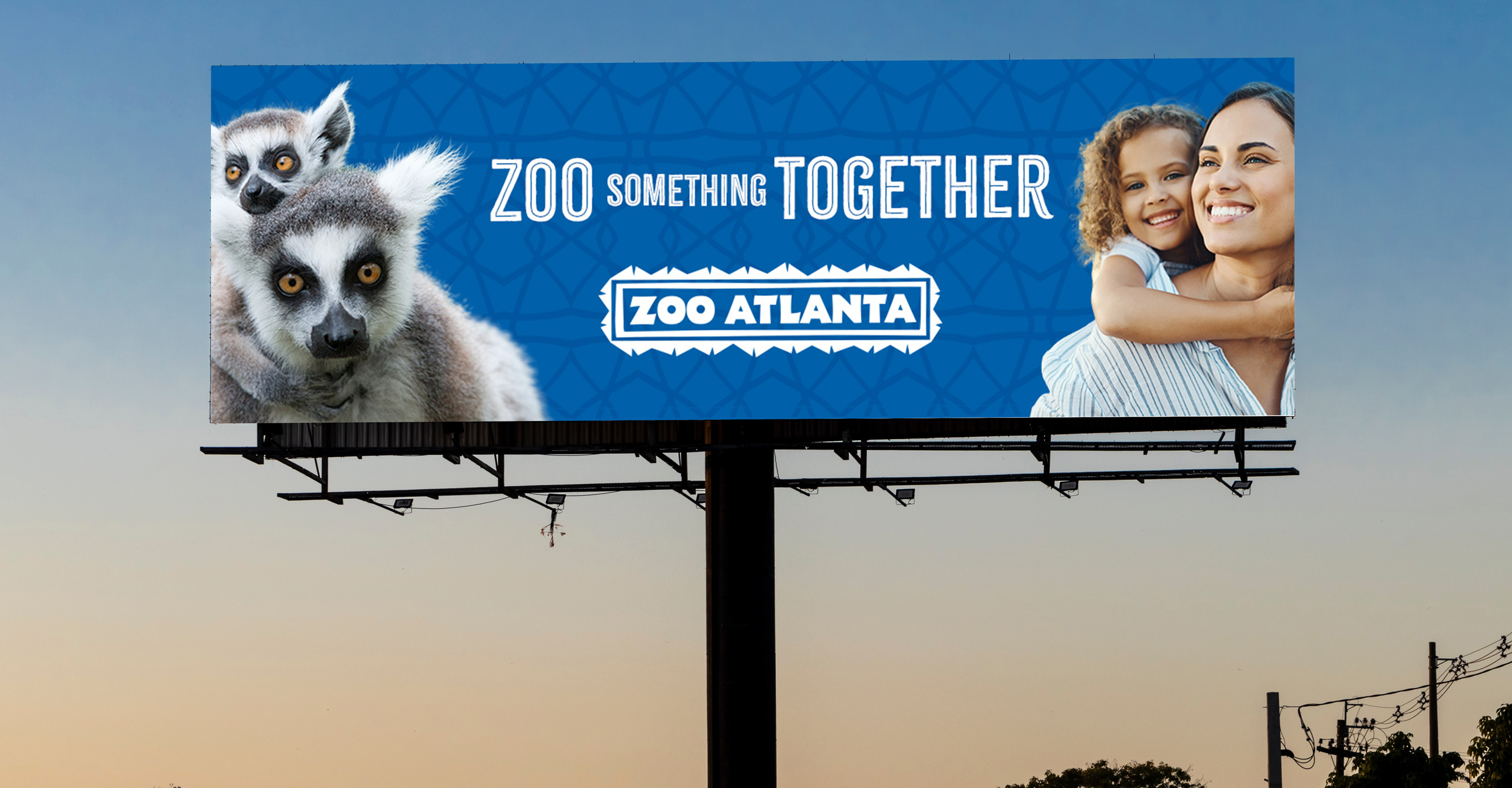 Zoo Atlanta billboard reading “ZOO Something Together,” with a mother an child on the right and a mother and baby lemur on the left.