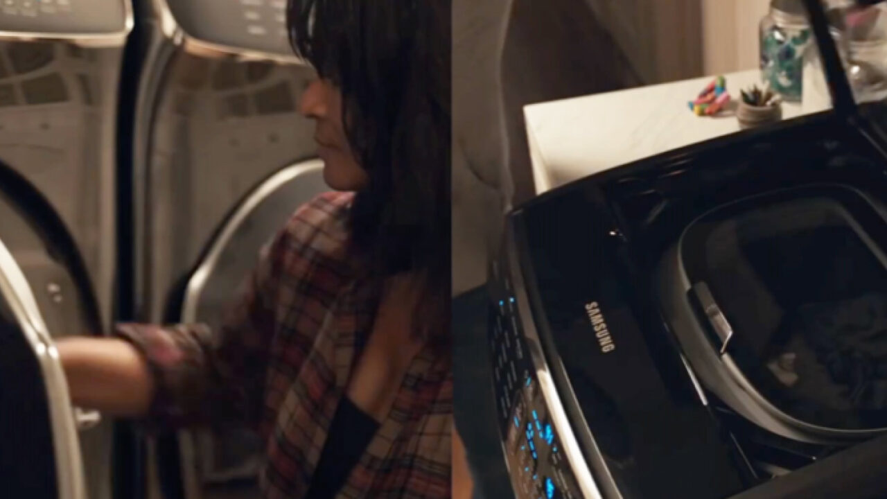 A woman using a Samsung dryer