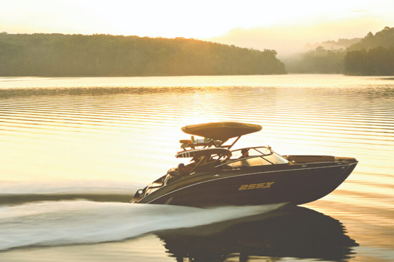 A Yamaha boat riding on still morning water